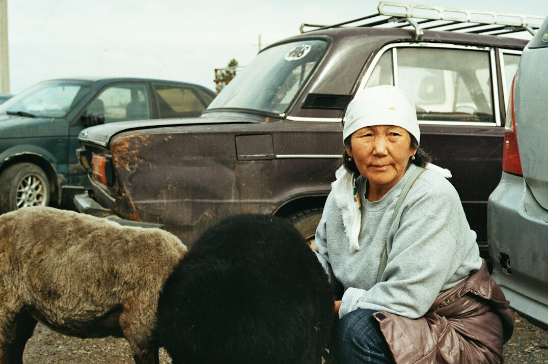 Elderly Polish woman selling vegetables at a local market stall