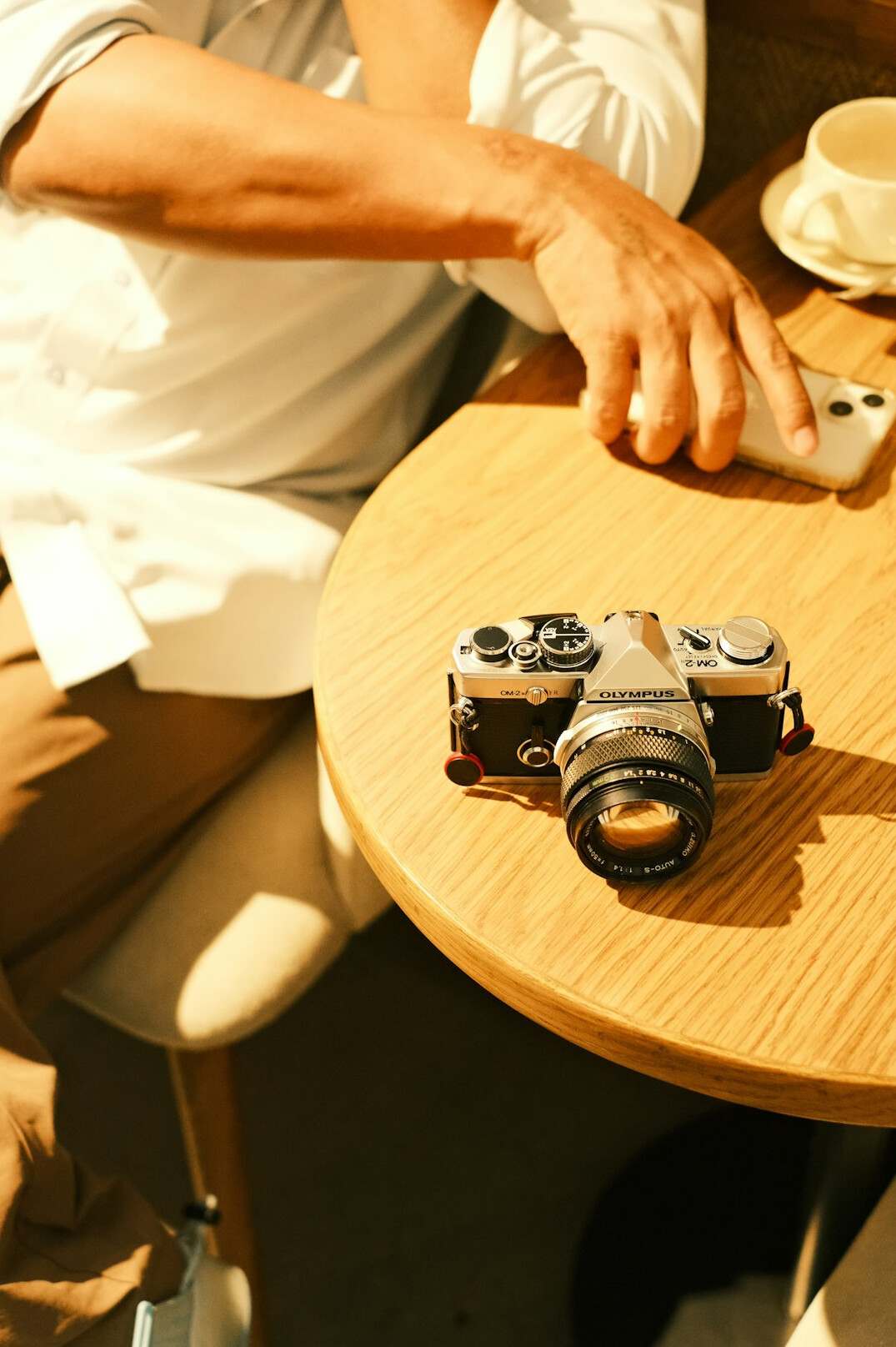 Photographer interviewing an elderly resident with notebook and camera