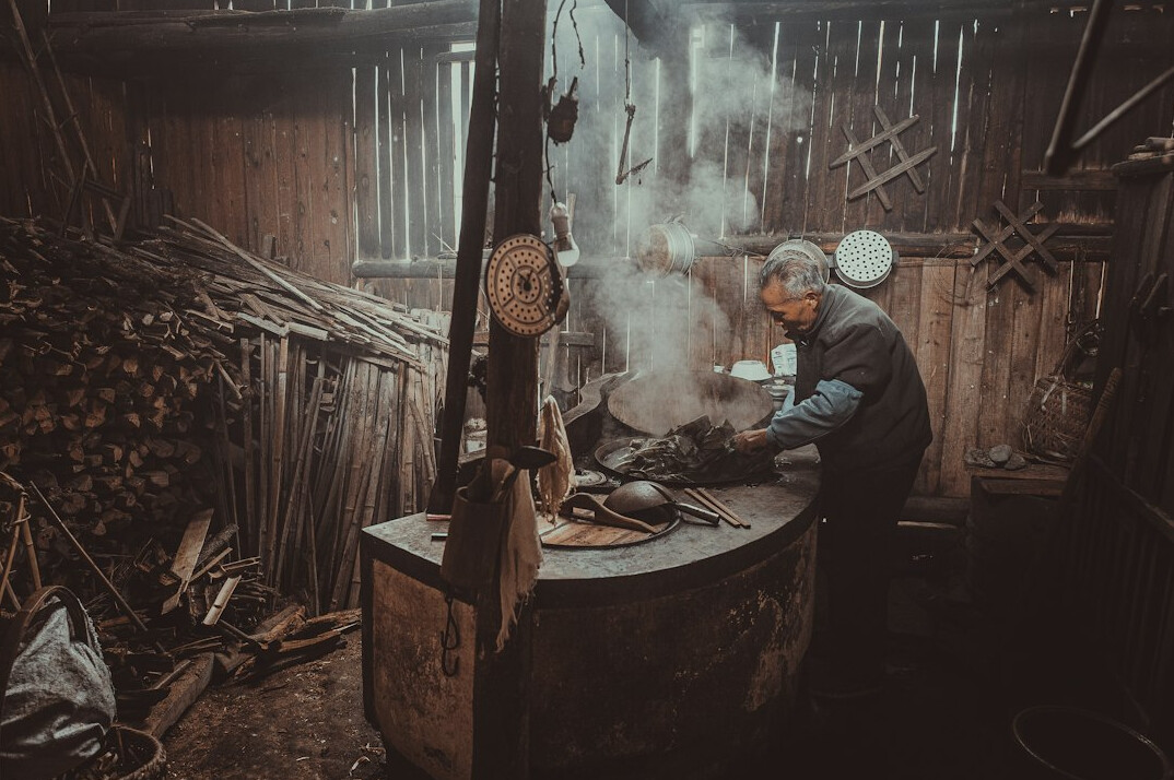 Polish blacksmith working with metal in a small workshop