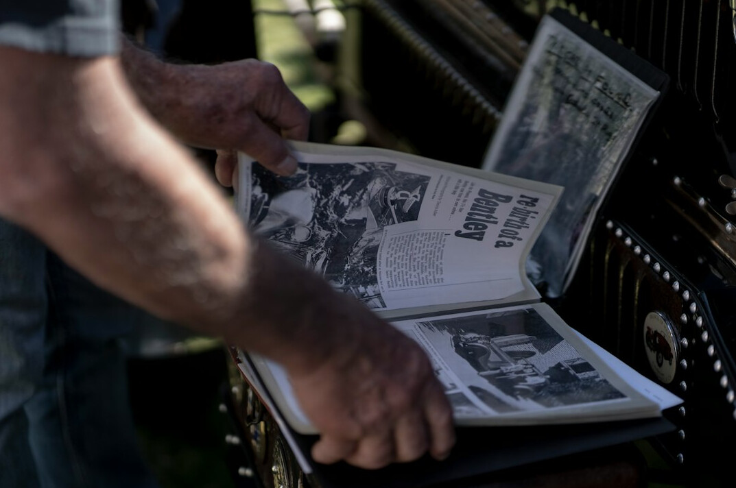 Photographer reviewing printed contact sheets and photo archive